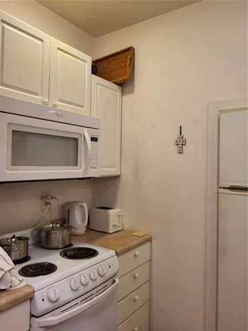 a kitchen with stainless steel appliances granite countertop a stove and a refrigerator
