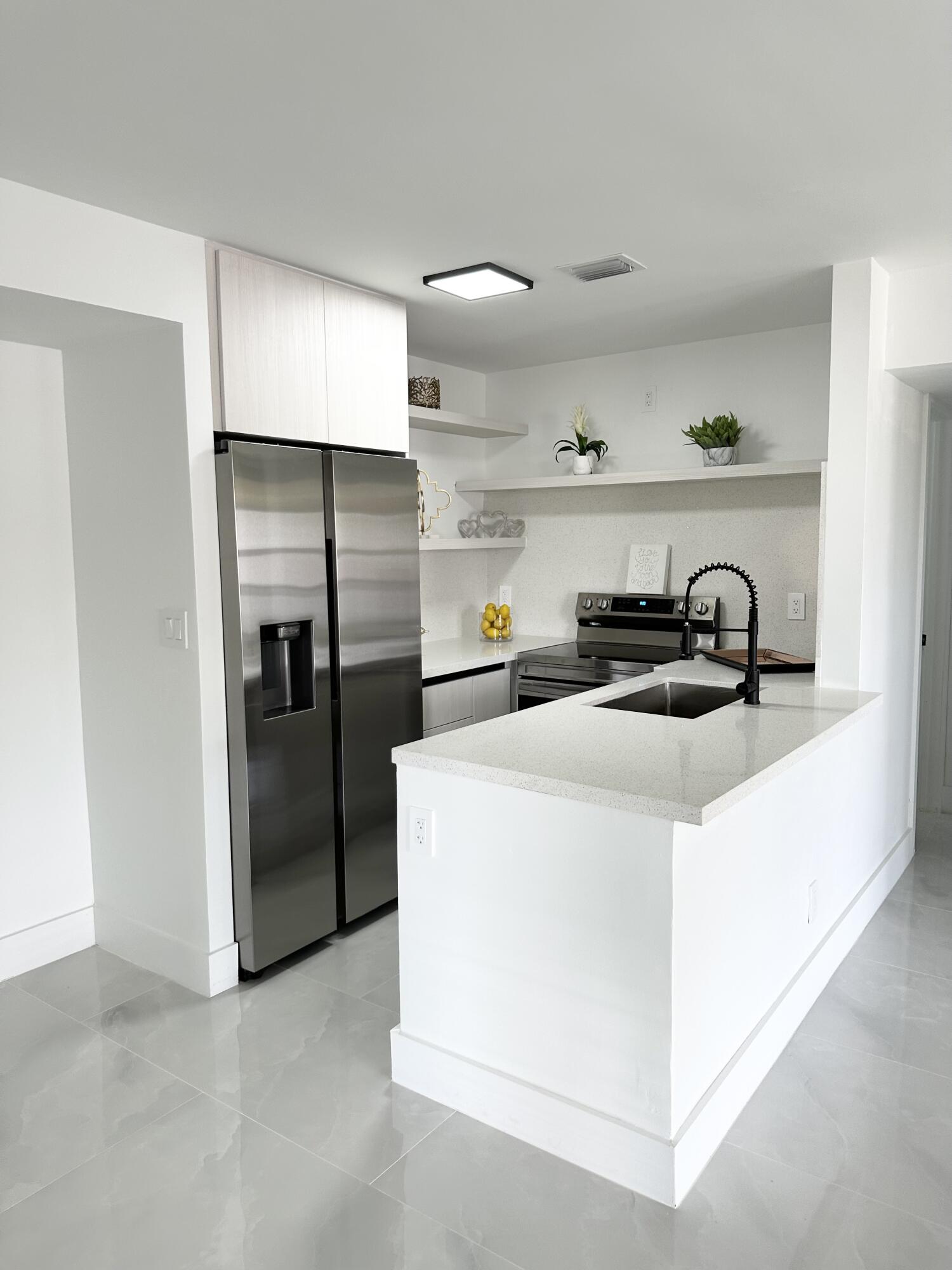 10033 Winding Lake Road, Unit 204 Sunrise, FL 33351 - Photo 12 of 37 a kitchen with a refrigerator and a stove top oven
