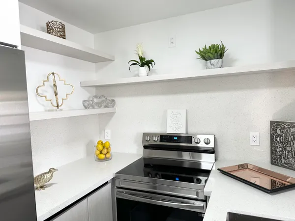 a view of kitchen appliances and wooden floor