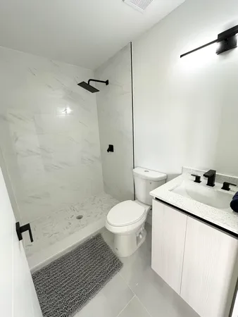 a bathroom with a sink toilet and shower