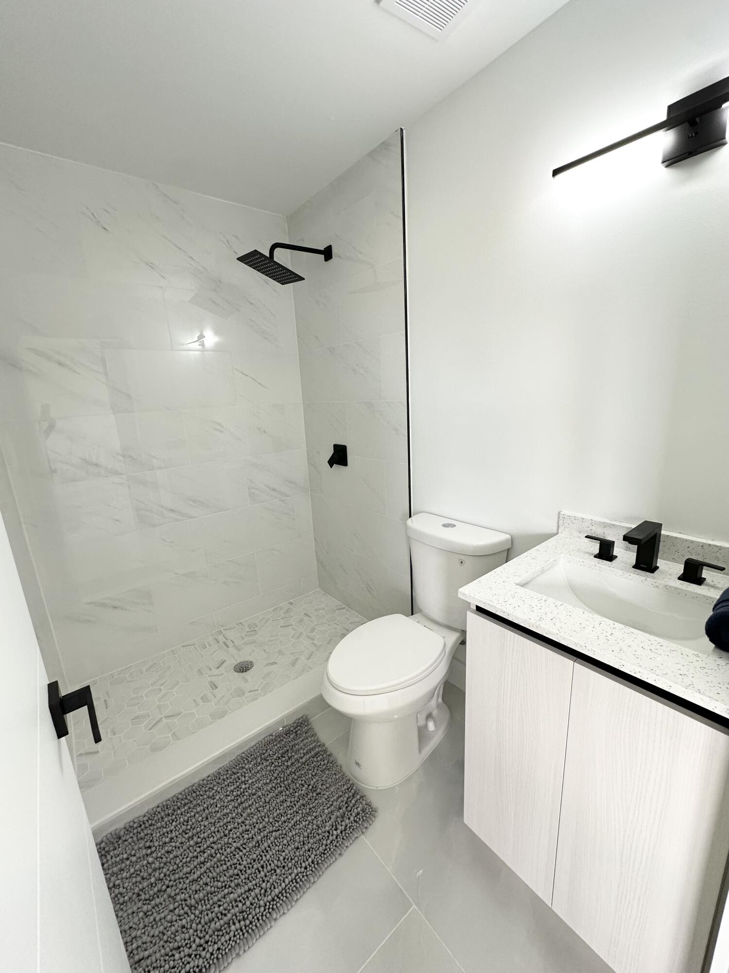 10033 Winding Lake Road, Unit 204 Sunrise, FL 33351 - Photo 16 of 37 a bathroom with a sink toilet and shower