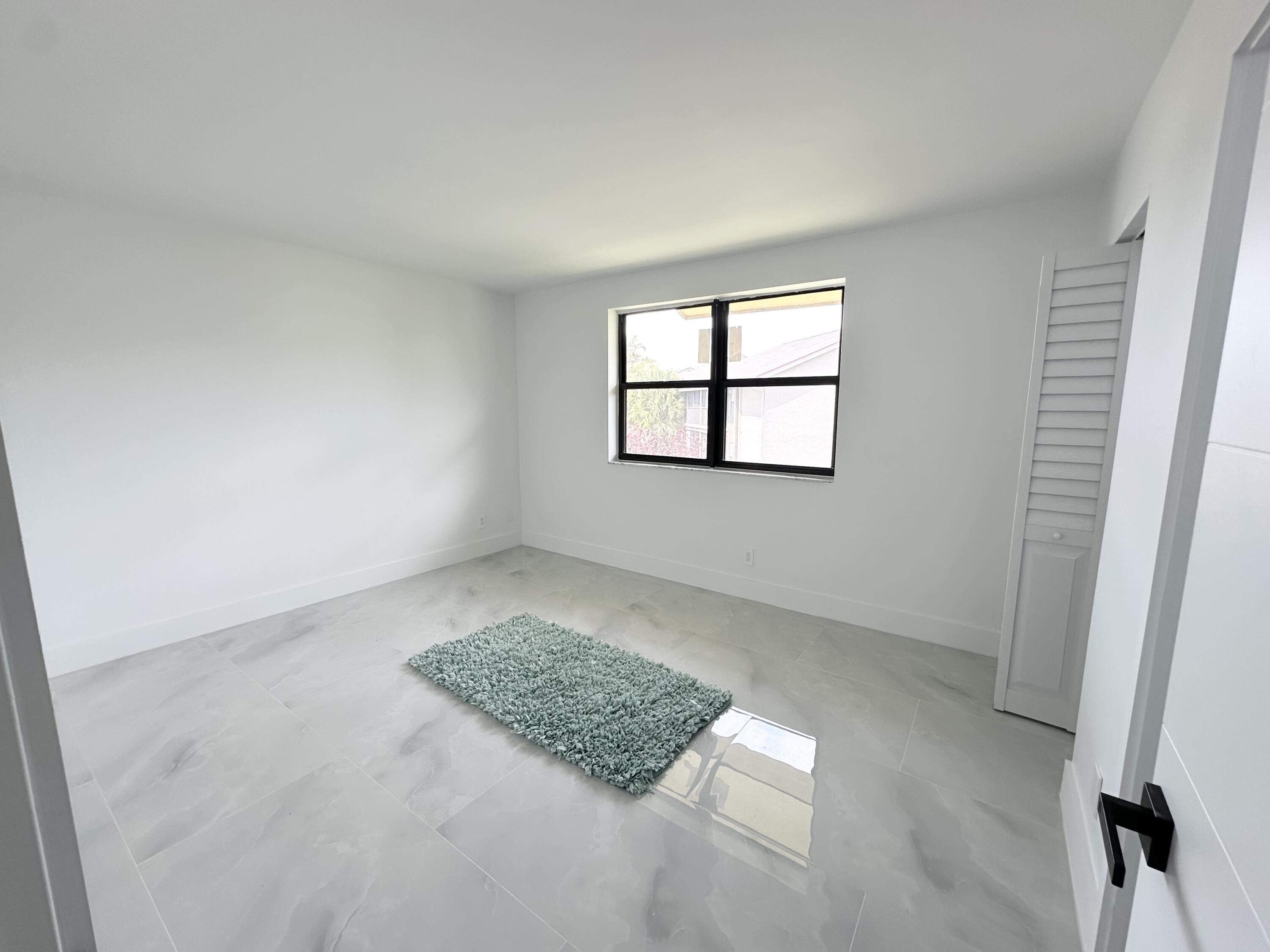 10033 Winding Lake Road, Unit 204 Sunrise, FL 33351 - Photo 17 of 37 an empty room with windows