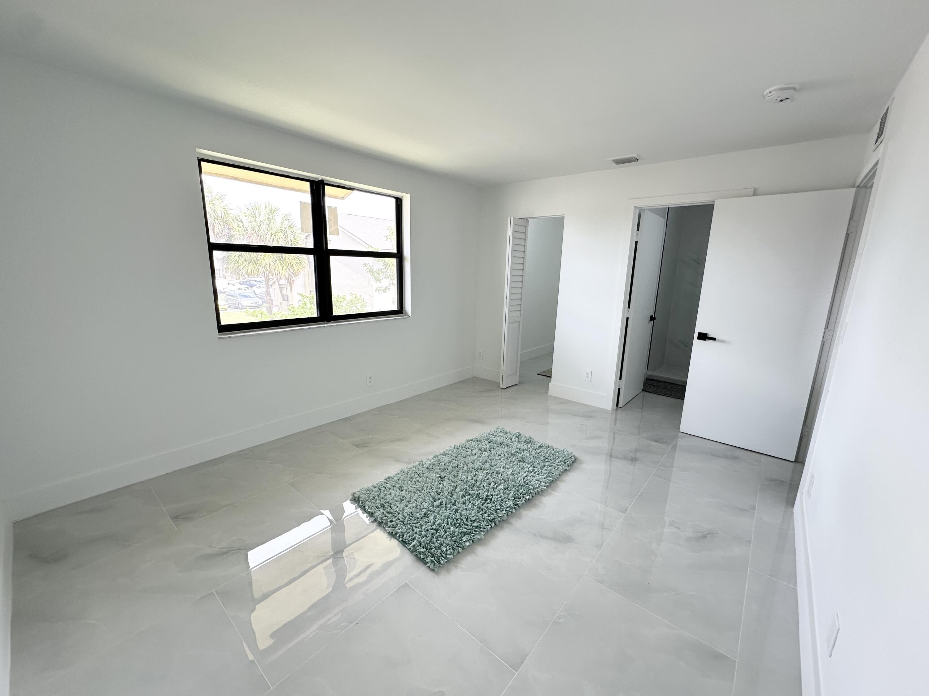 10033 Winding Lake Road, Unit 204 Sunrise, FL 33351 - Photo 18 of 37 an empty room with windows