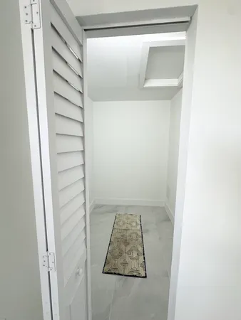 a living room with furniture and a dresser