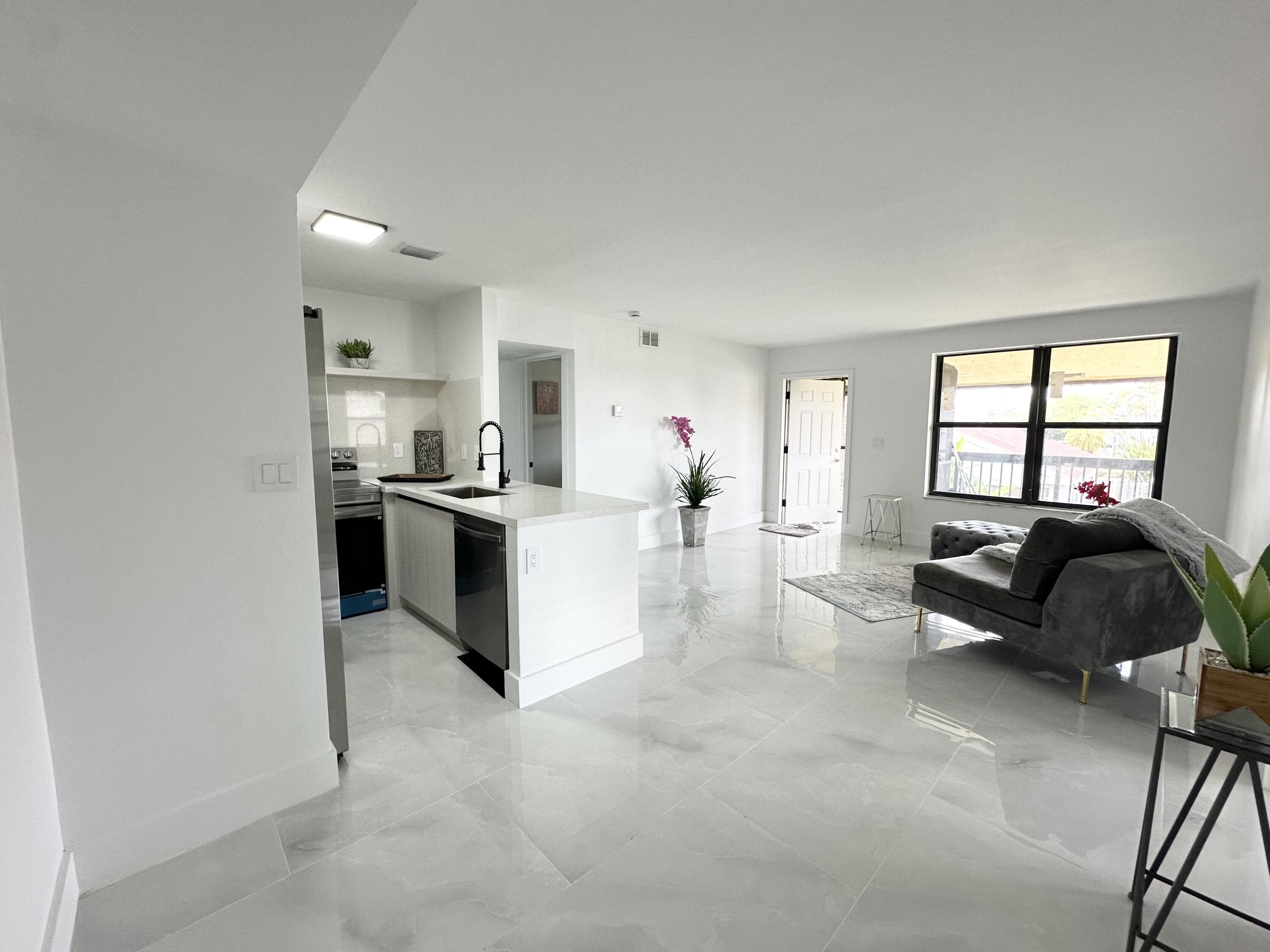 10033 Winding Lake Road, Unit 204 Sunrise, FL 33351 - Photo 23 of 37 a living room with furniture and a dresser
