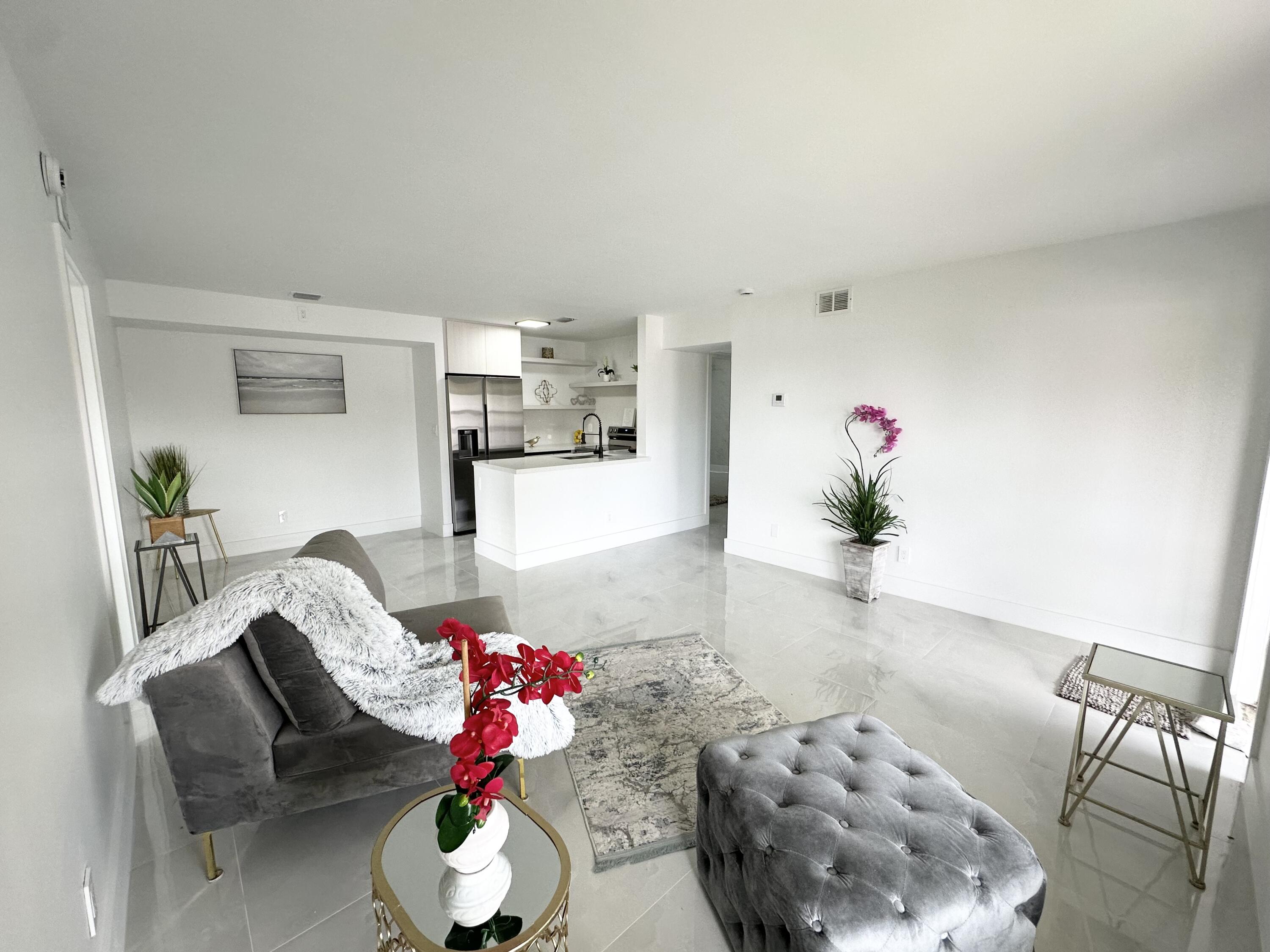 10033 Winding Lake Road, Unit 204 Sunrise, FL 33351 - Photo 24 of 37 a living room with furniture and flowers