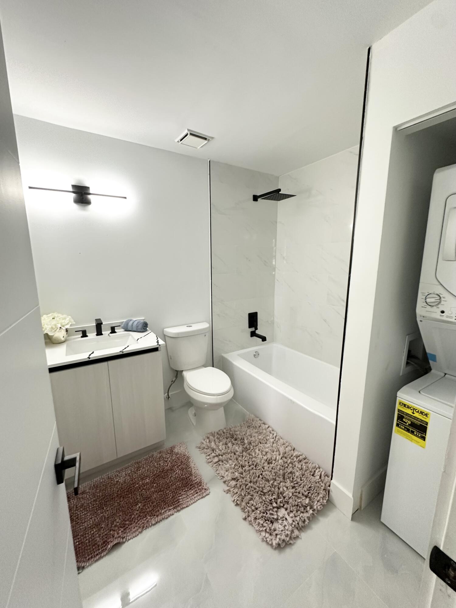 10033 Winding Lake Road, Unit 204 Sunrise, FL 33351 - Photo 26 of 37 a bathroom with a sink a toilet and bathtub