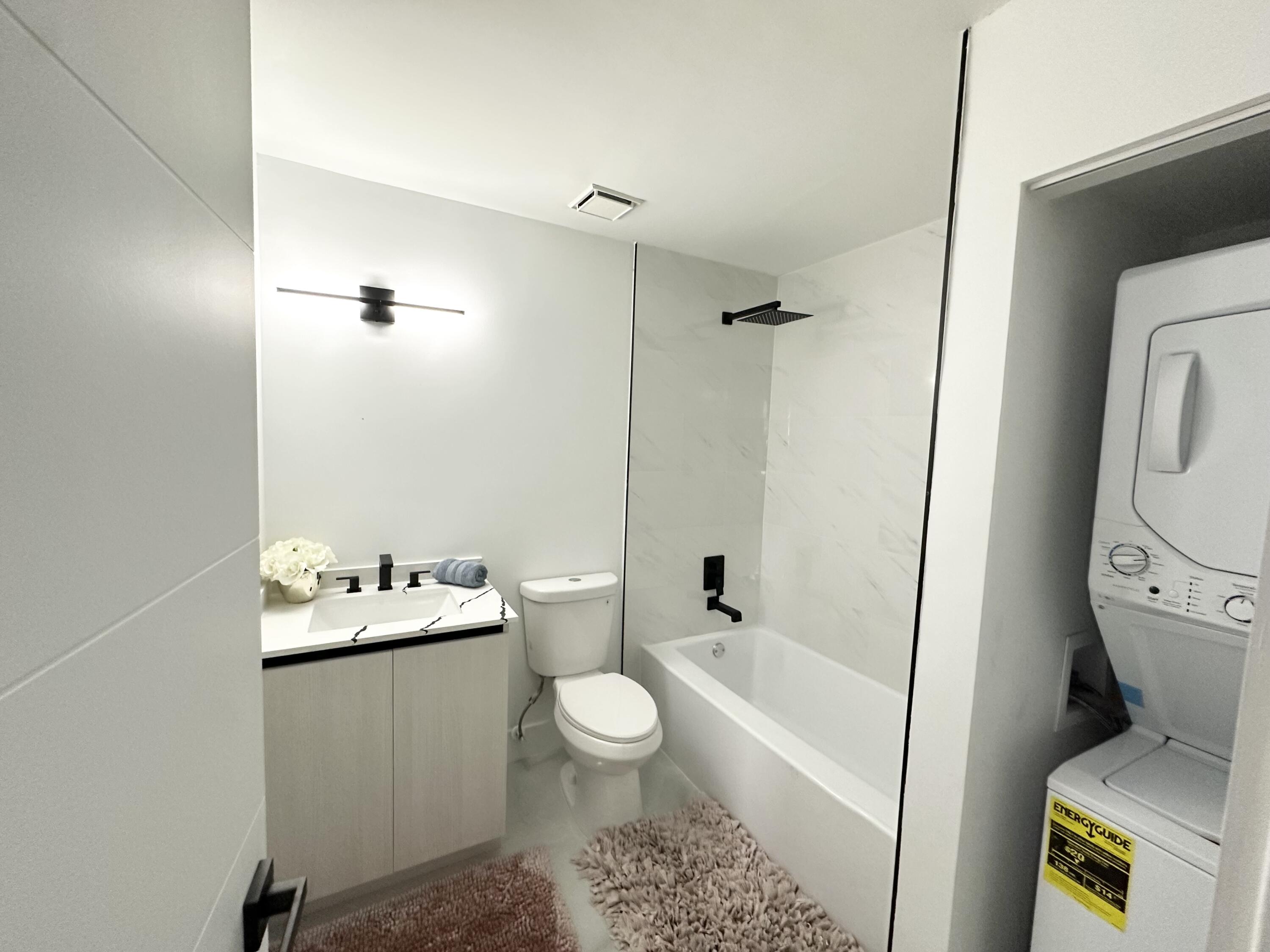 10033 Winding Lake Road, Unit 204 Sunrise, FL 33351 - Photo 27 of 37 a bathroom with a sink toilet and shower