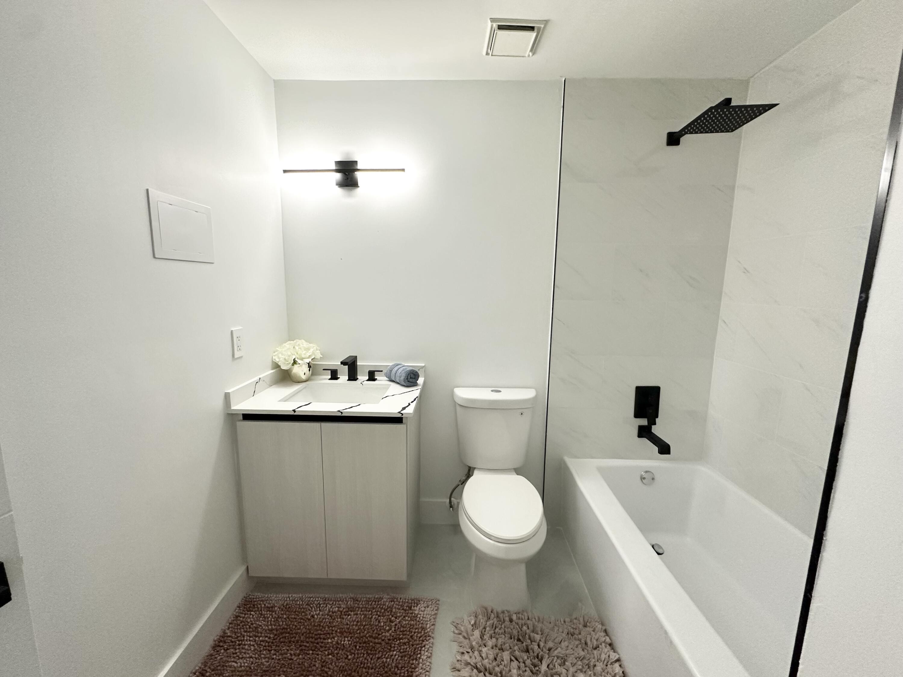 10033 Winding Lake Road, Unit 204 Sunrise, FL 33351 - Photo 30 of 37 a bathroom with a sink toilet and shower