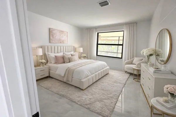 a bedroom with a bed a mirror and a window
