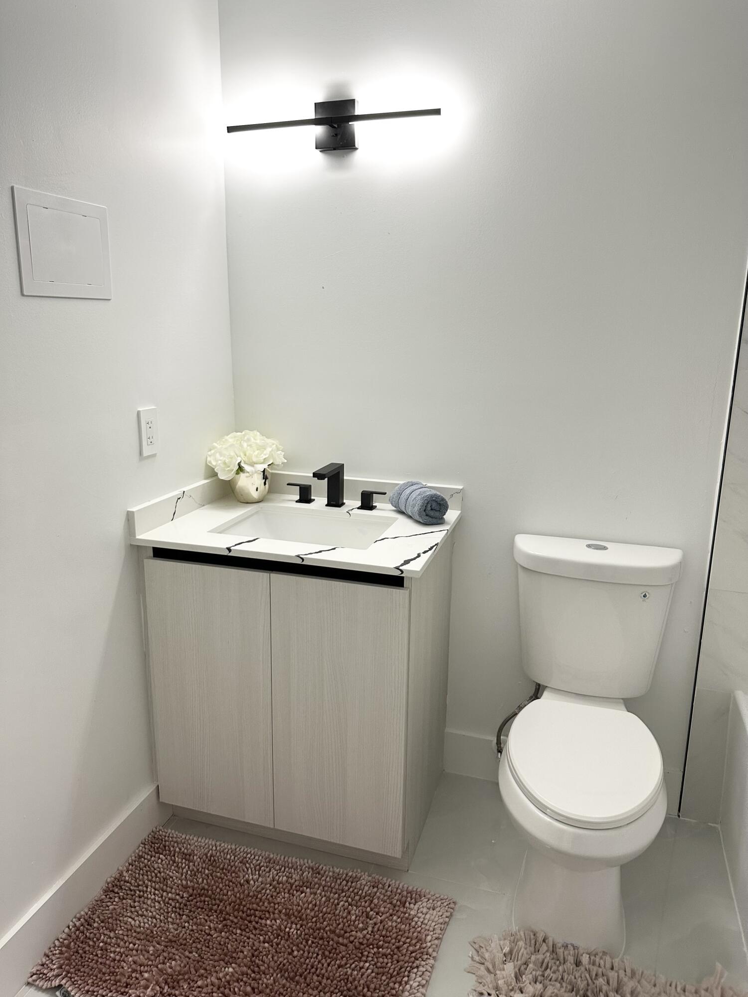 10033 Winding Lake Road, Unit 204 Sunrise, FL 33351 - Photo 33 of 37 a bathroom with a sink a toilet and a mirror