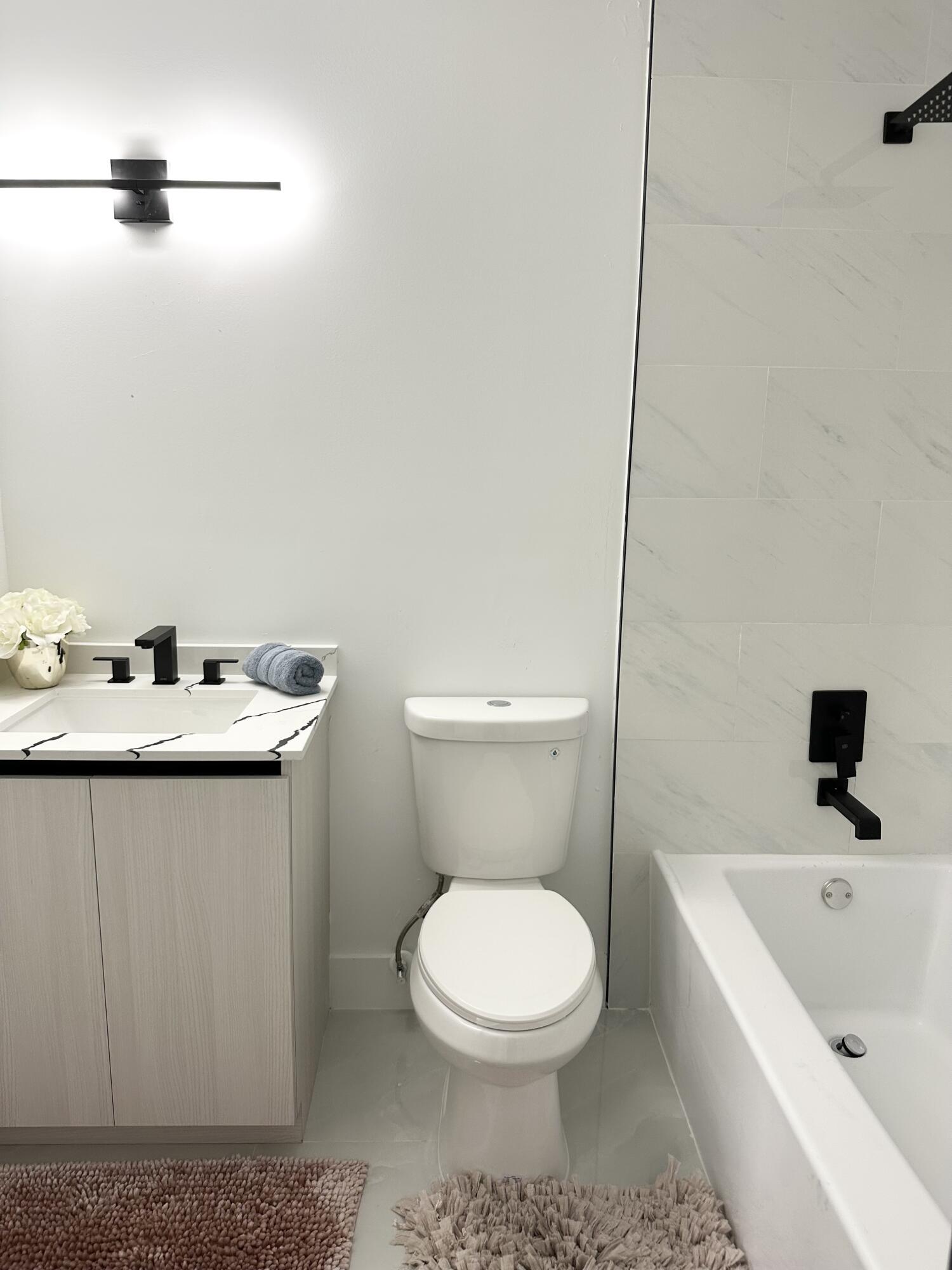 10033 Winding Lake Road, Unit 204 Sunrise, FL 33351 - Photo 34 of 37 a bathroom with a sink a toilet and a bathtub