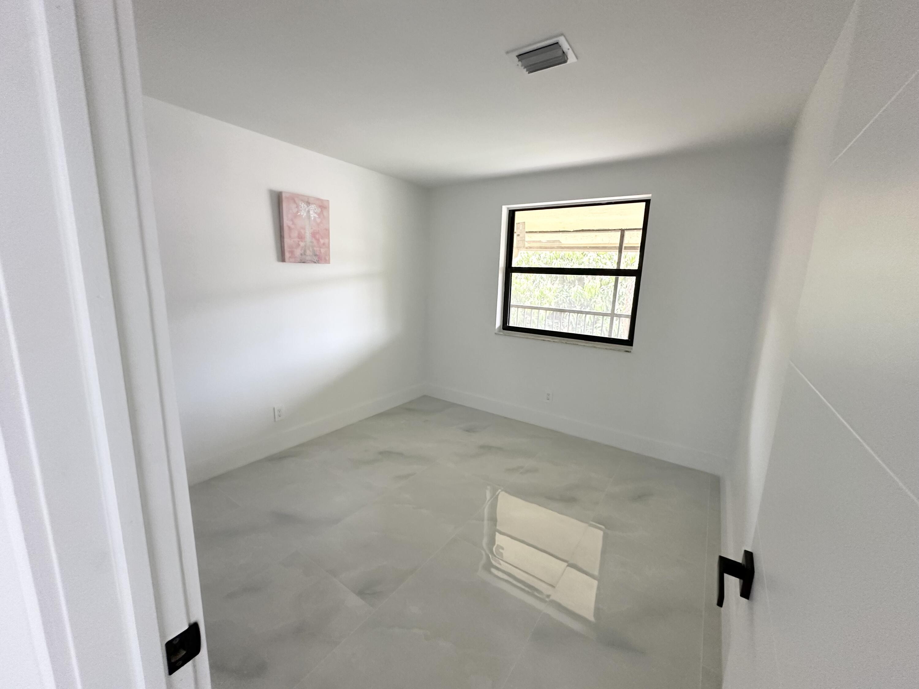 10033 Winding Lake Road, Unit 204 Sunrise, FL 33351 - Photo 35 of 37 an empty room with windows