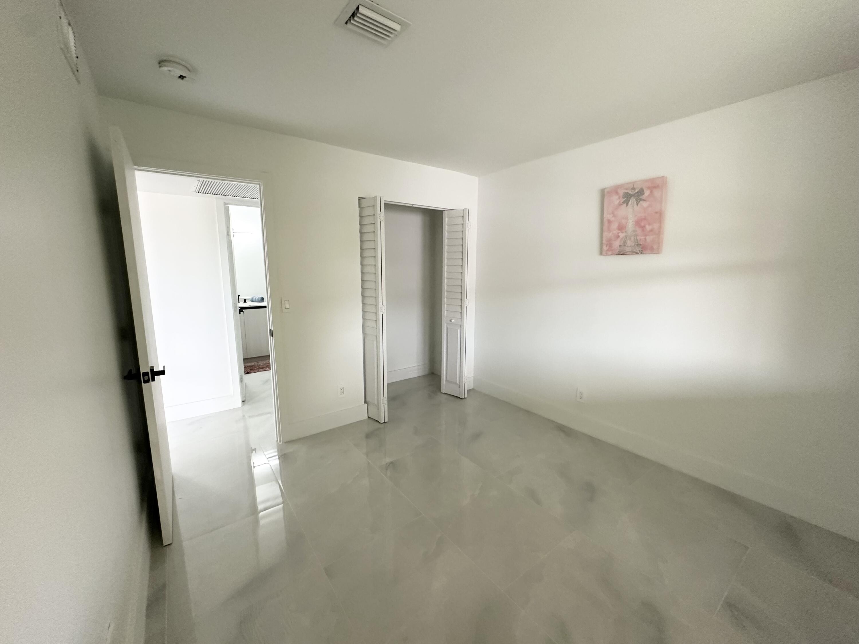 10033 Winding Lake Road, Unit 204 Sunrise, FL 33351 - Photo 36 of 37 an empty room with a refrigerator