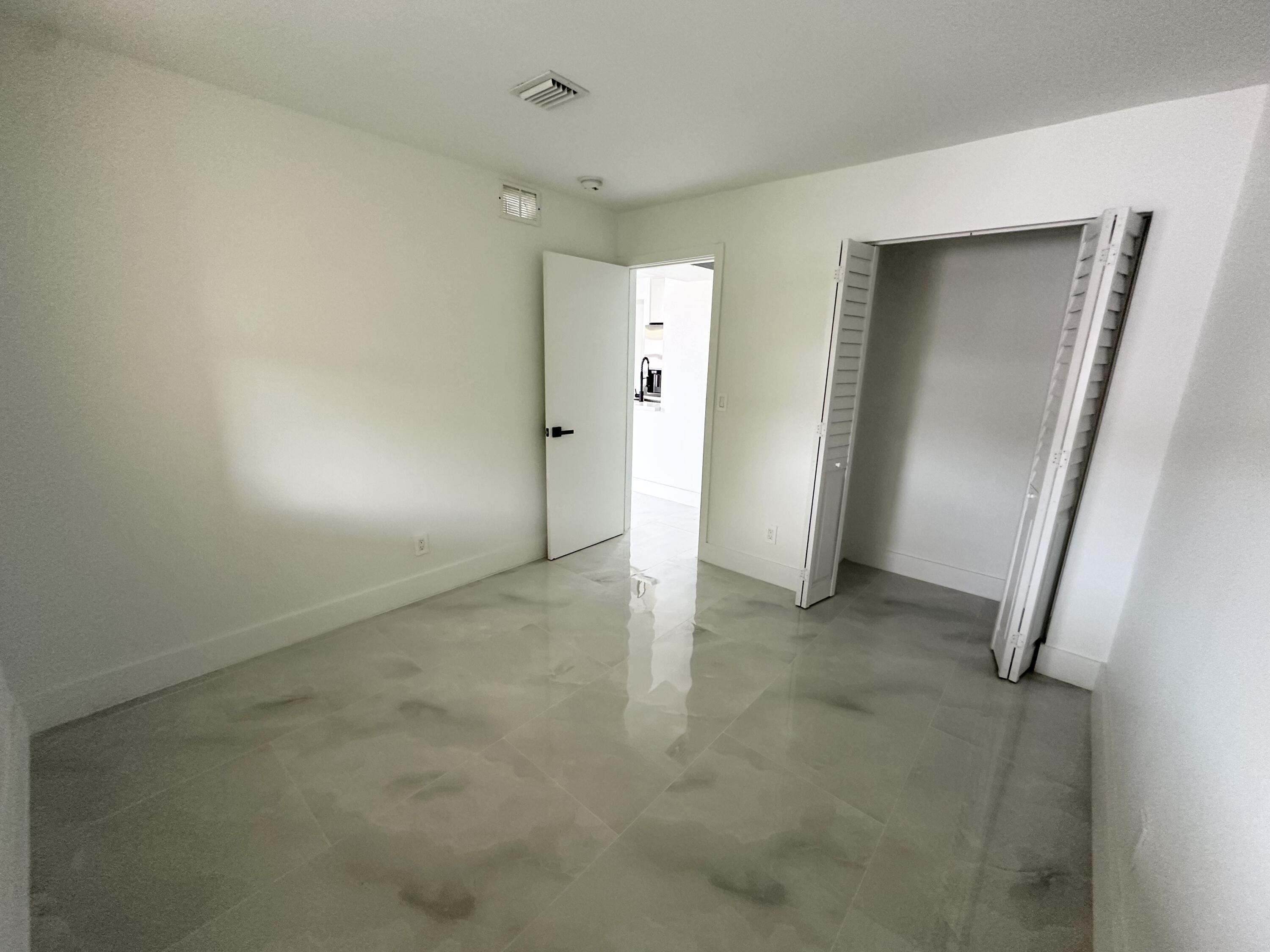 10033 Winding Lake Road, Unit 204 Sunrise, FL 33351 - Photo 37 of 37 an empty room with closet and mirror