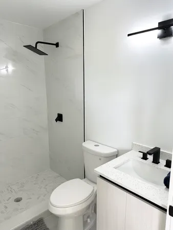 a white toilet sitting next to a bathroom sink