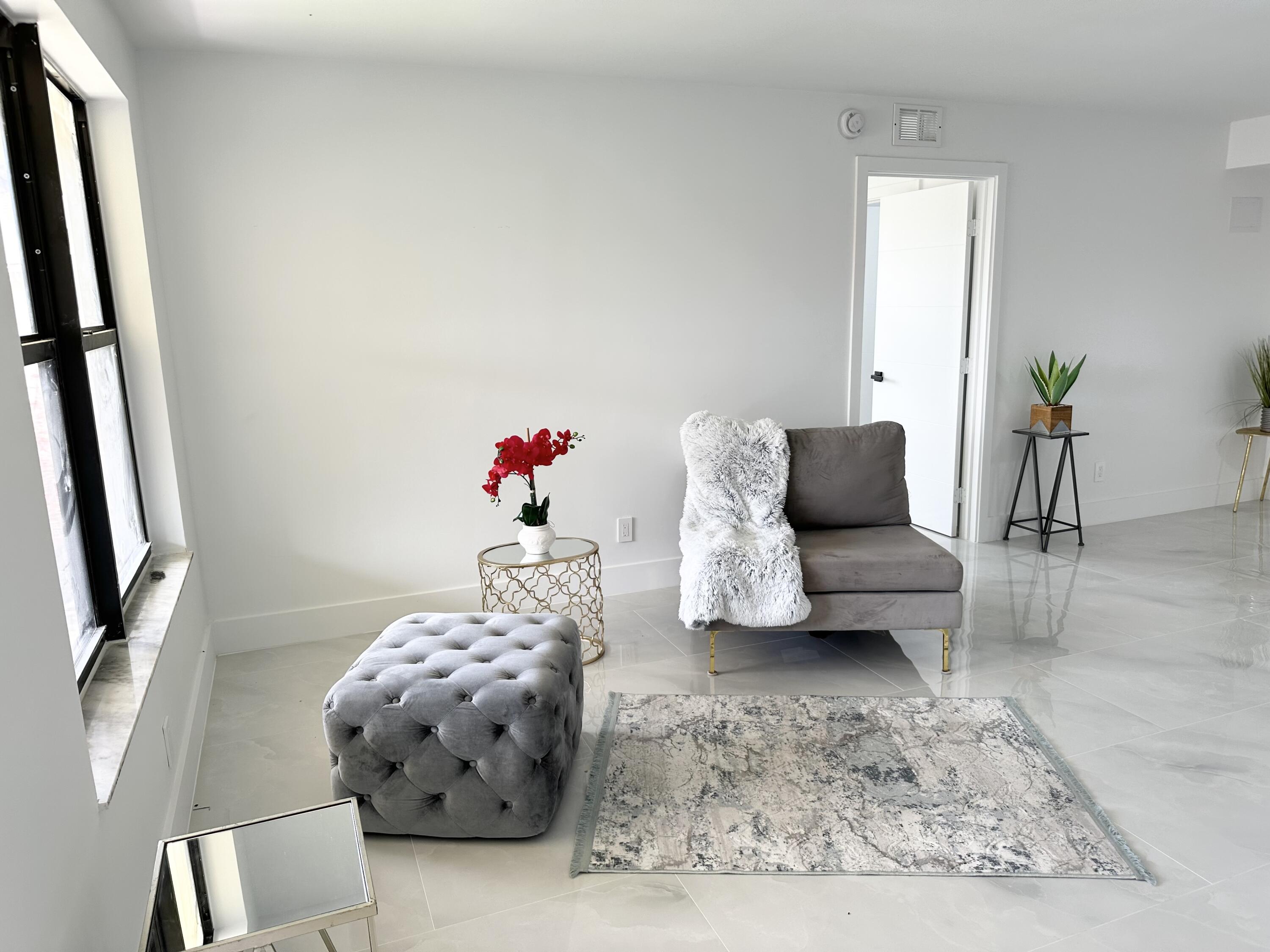 10033 Winding Lake Road, Unit 204 Sunrise, FL 33351 - Photo 5 of 37 a living room with furniture and a mirror
