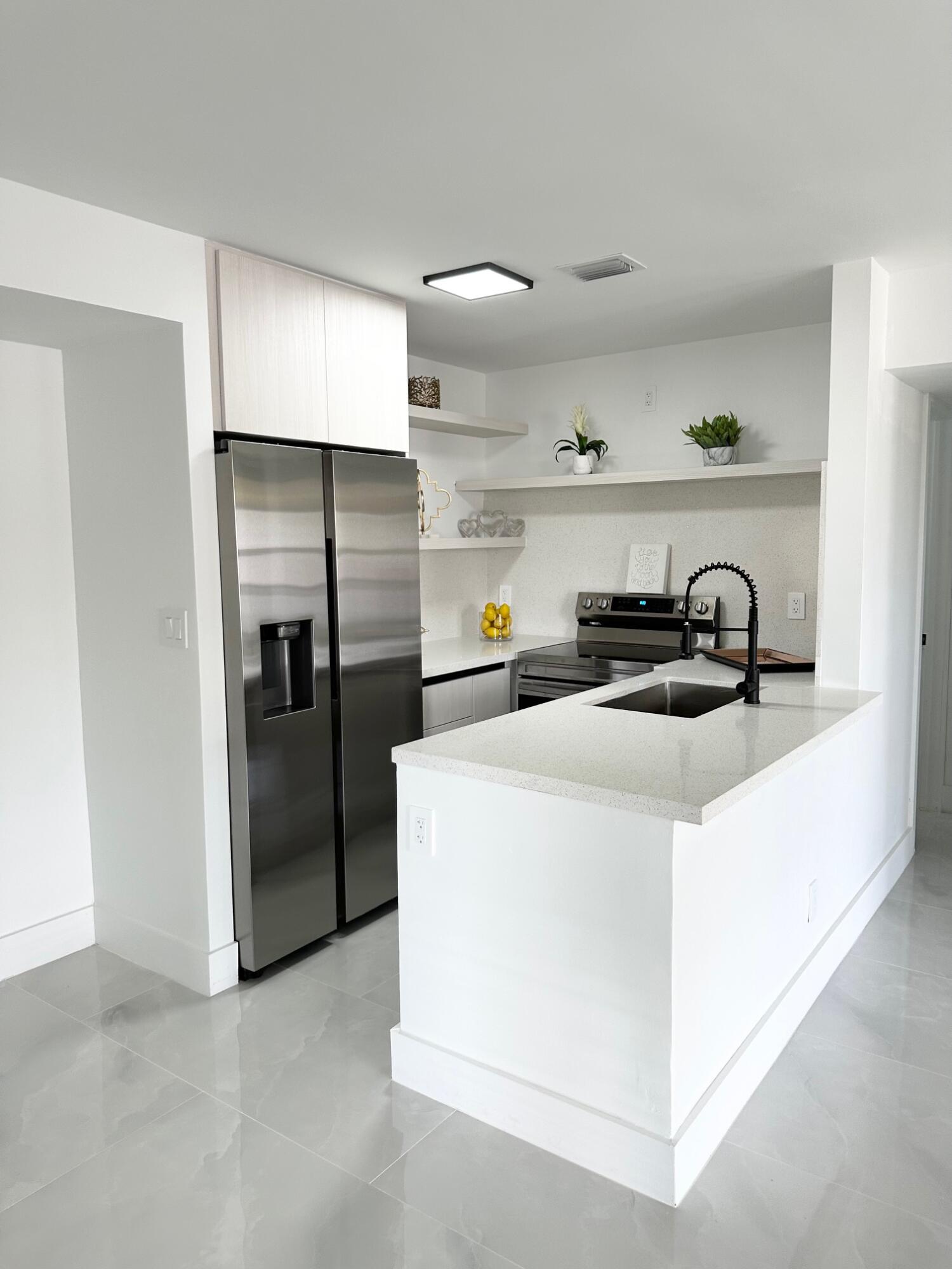 10033 Winding Lake Road, Unit 204 Sunrise, FL 33351 - Photo 9 of 37 a kitchen with a refrigerator and a stove top oven