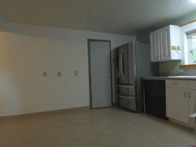 a kitchen with a refrigerator stove and cabinets