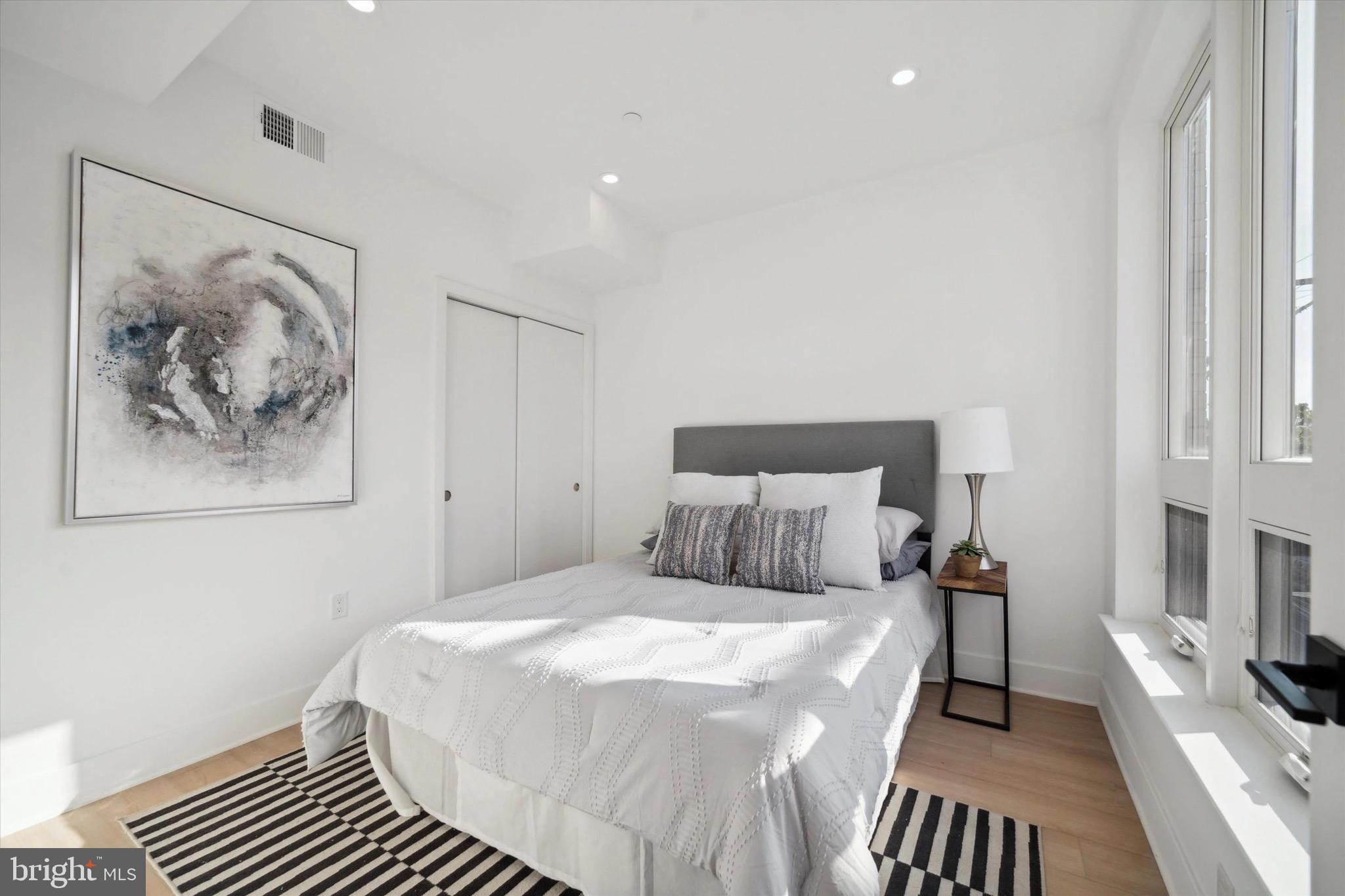 1643 North 2nd Street, Unit 302 Philadelphia, PA 19122 - Photo 12 of 40 a bedroom with a bed and a painting on the wall