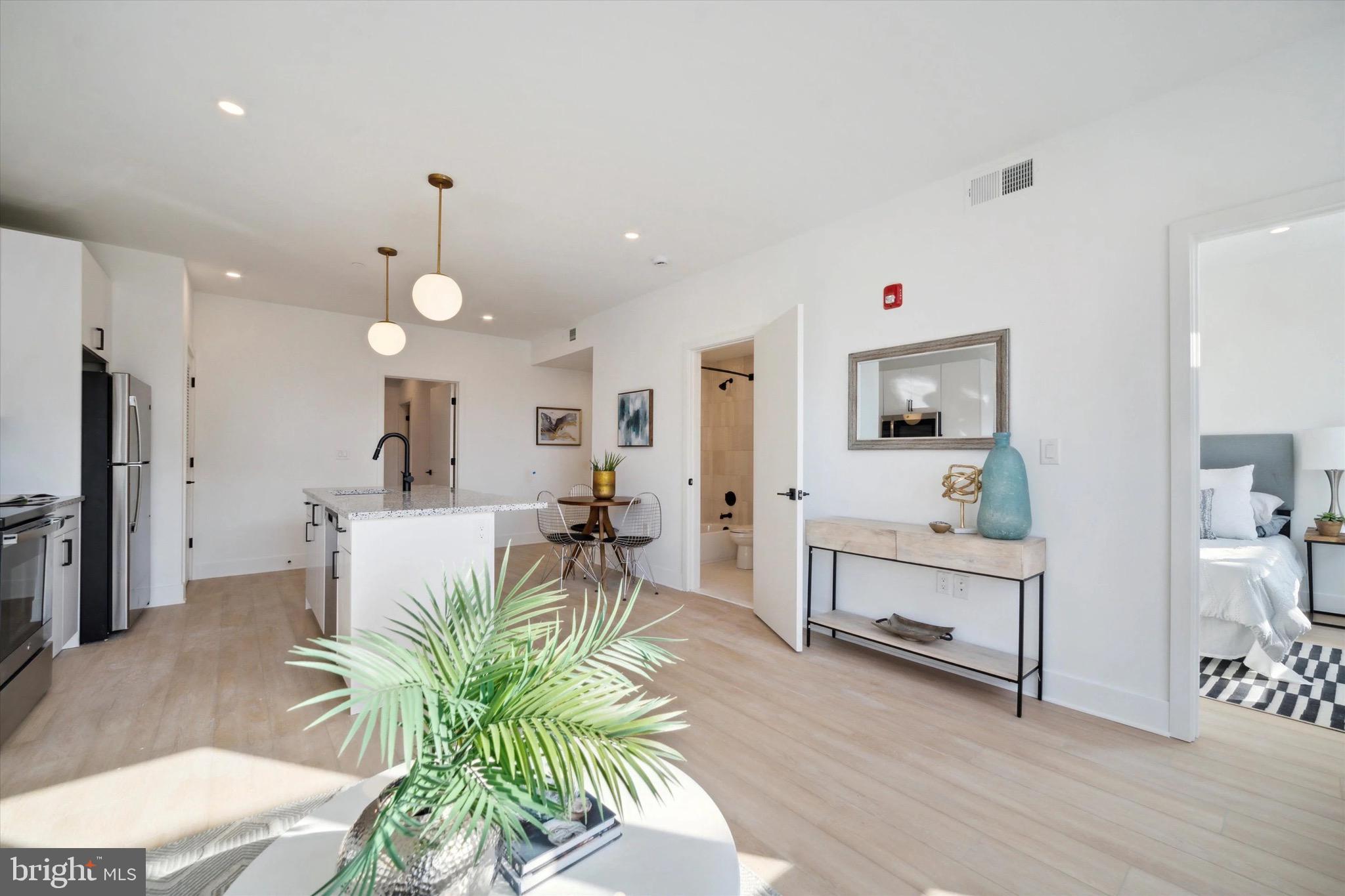 1643 North 2nd Street, Unit 302 Philadelphia, PA 19122 - Photo 15 of 40 a living room with furniture potted plant and kitchen view