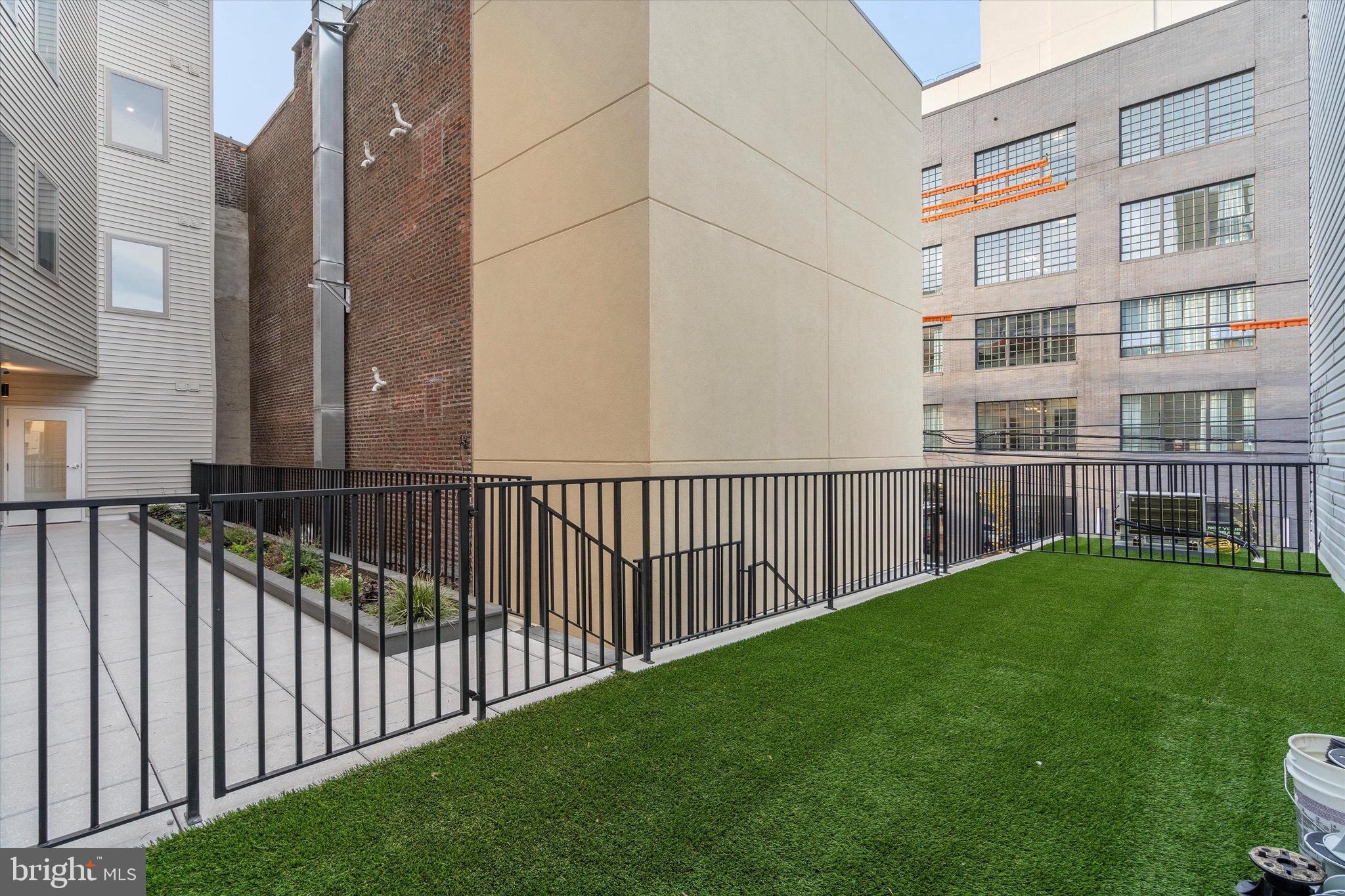 1643 North 2nd Street, Unit 302 Philadelphia, PA 19122 - Photo 23 of 40 a view of a brick building next to a yard