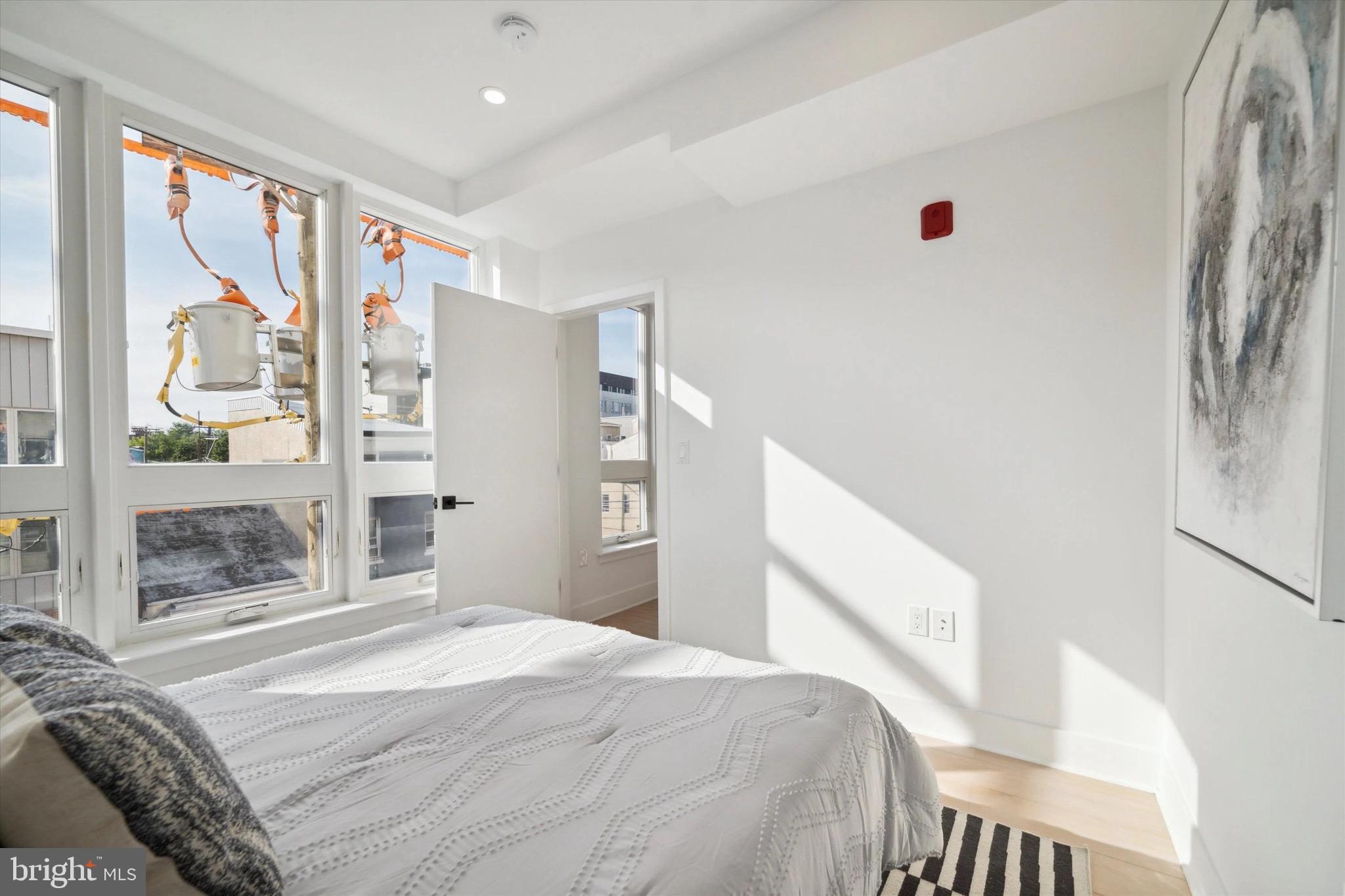 1643 North 2nd Street, Unit 302 Philadelphia, PA 19122 - Photo 35 of 40 a bedroom with a bed and a window with the outer view