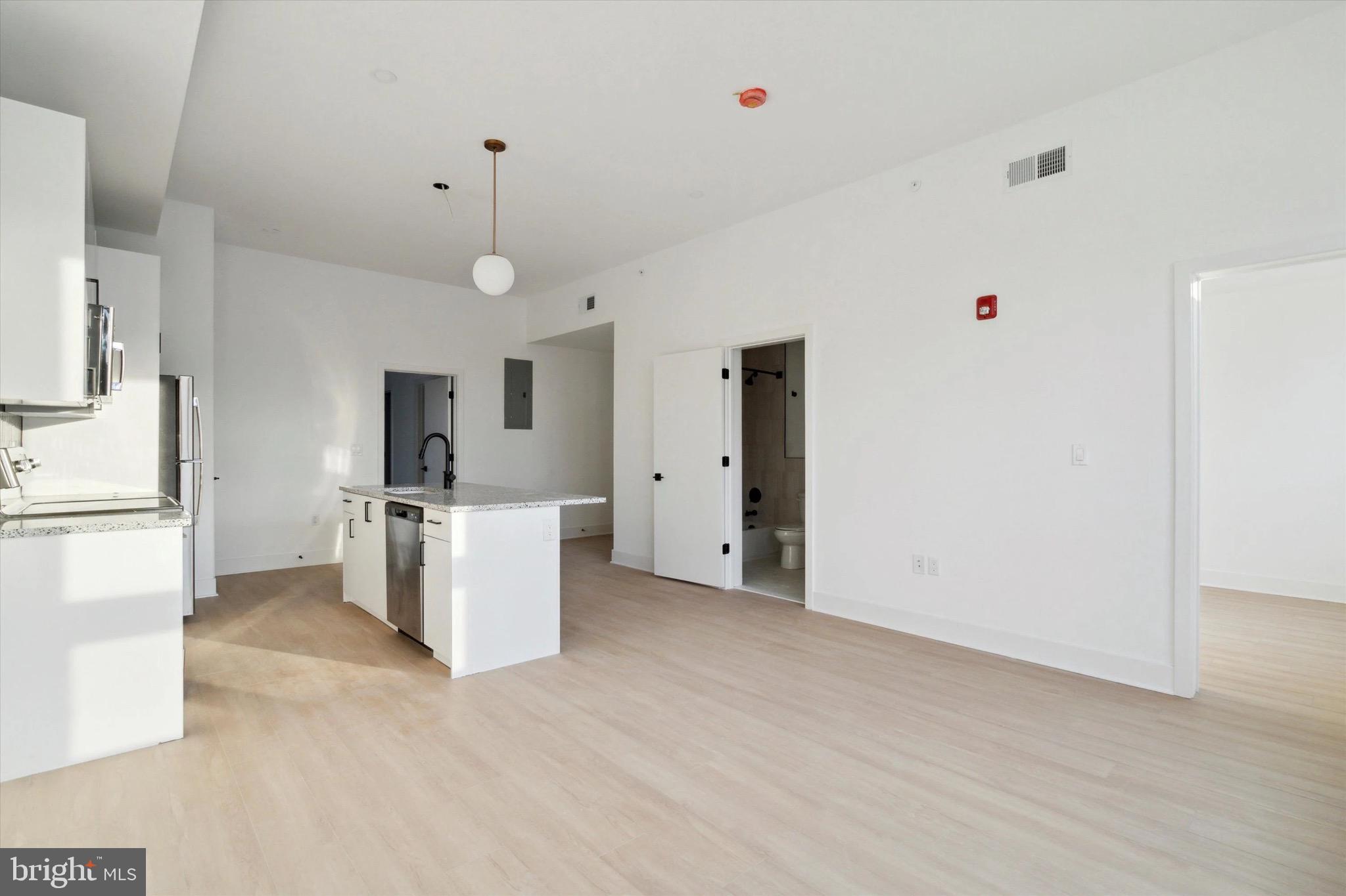 1643 North 2nd Street, Unit 302 Philadelphia, PA 19122 - Photo 5 of 40 a view of a kitchen with refrigerator and a stove top oven