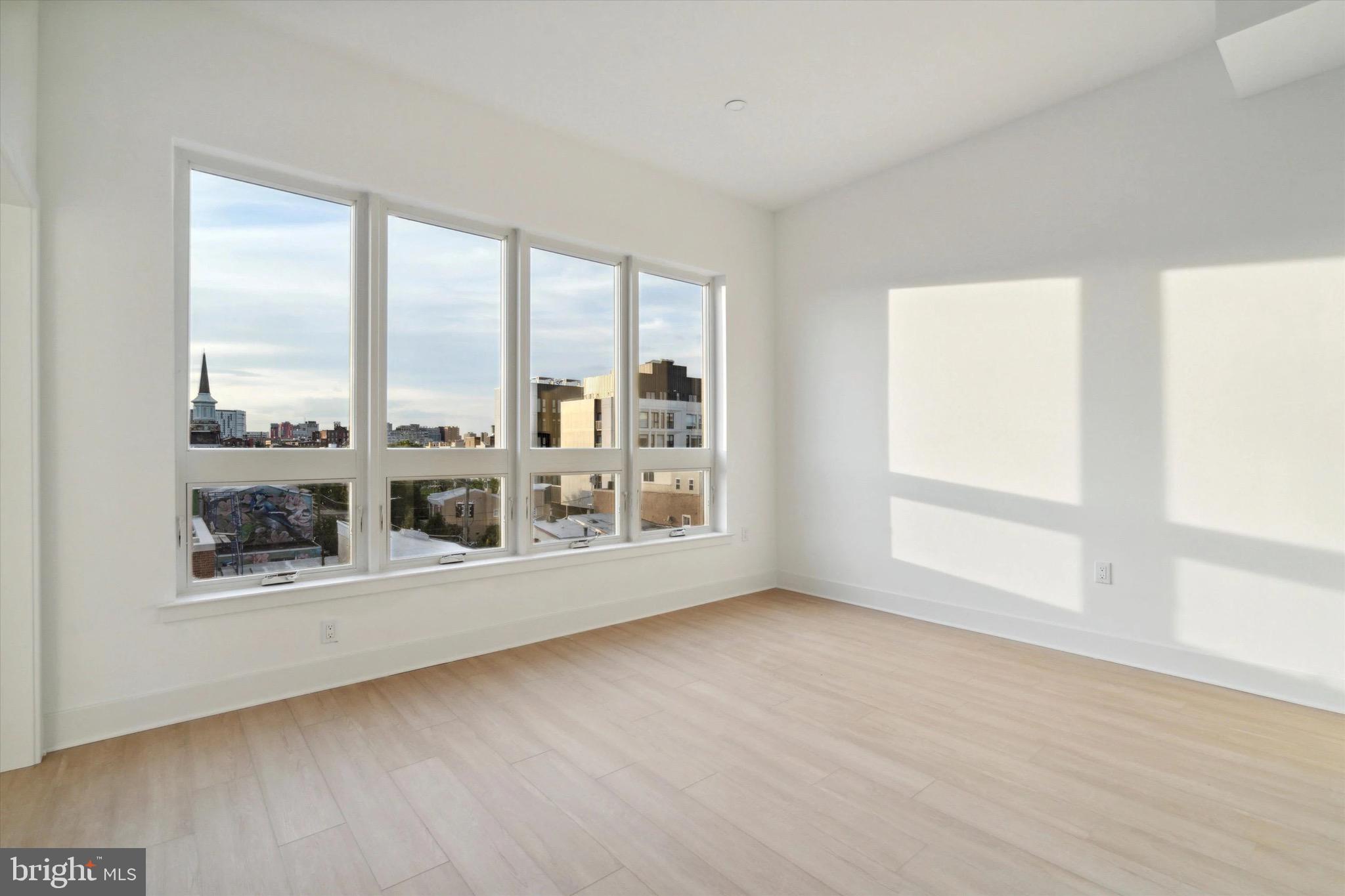 1643 North 2nd Street, Unit 302 Philadelphia, PA 19122 - Photo 6 of 40 a view of a big room with wooden floor and windows