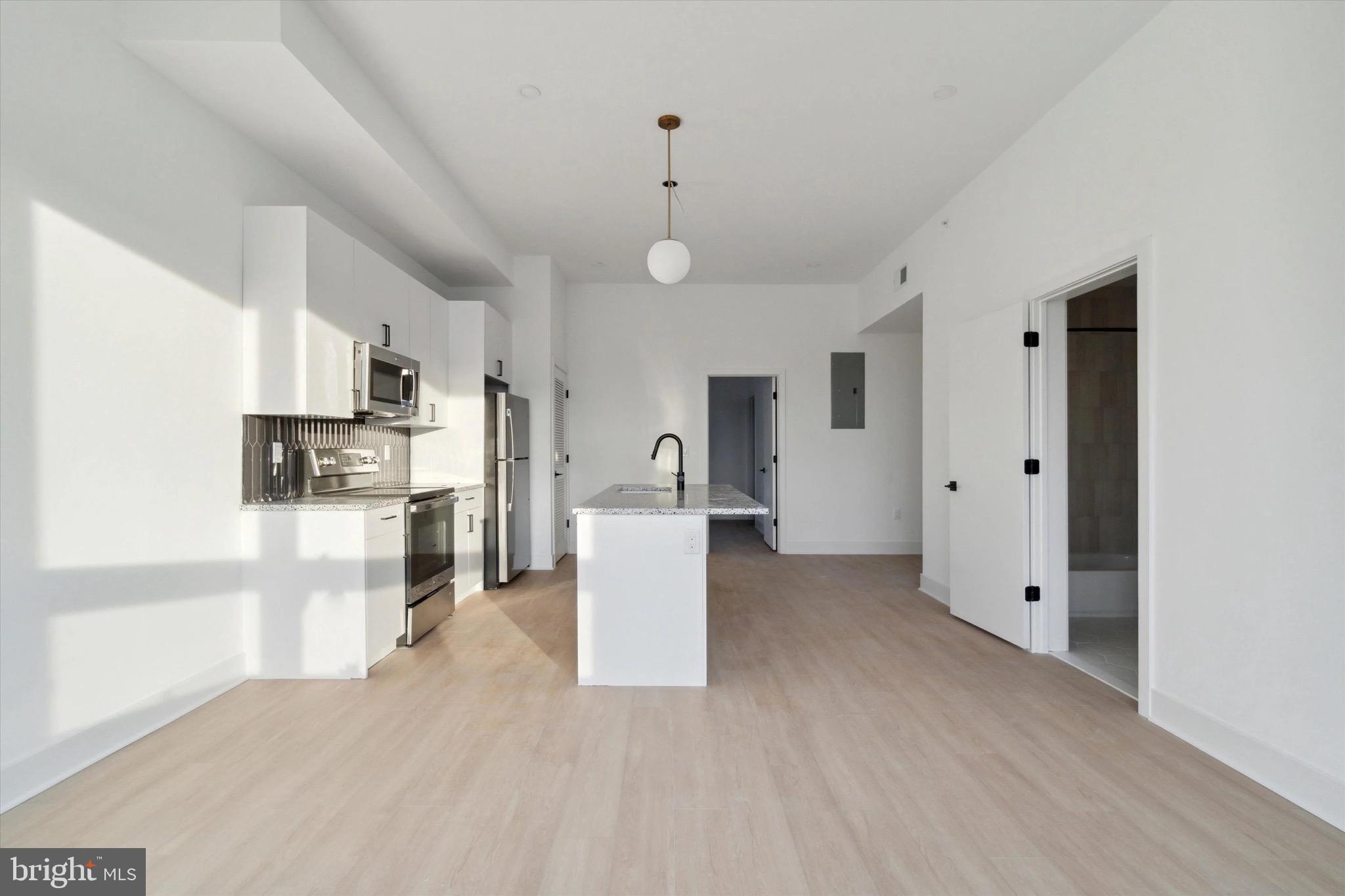 1643 North 2nd Street, Unit 302 Philadelphia, PA 19122 - Photo 9 of 40 a kitchen with stainless steel appliances a refrigerator and a stove top oven