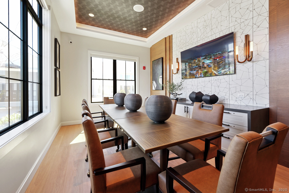 6 Whisper Rdg Way, Unit 42 Woodbridge, CT 06525 - Photo 14 of 17 a view of a dining room with furniture and a potted plant