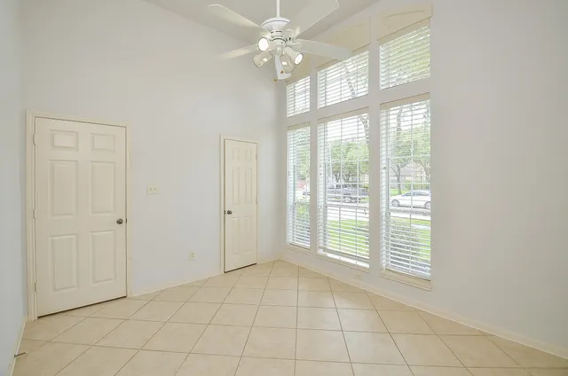 a bedroom with a balcony a bed and a window