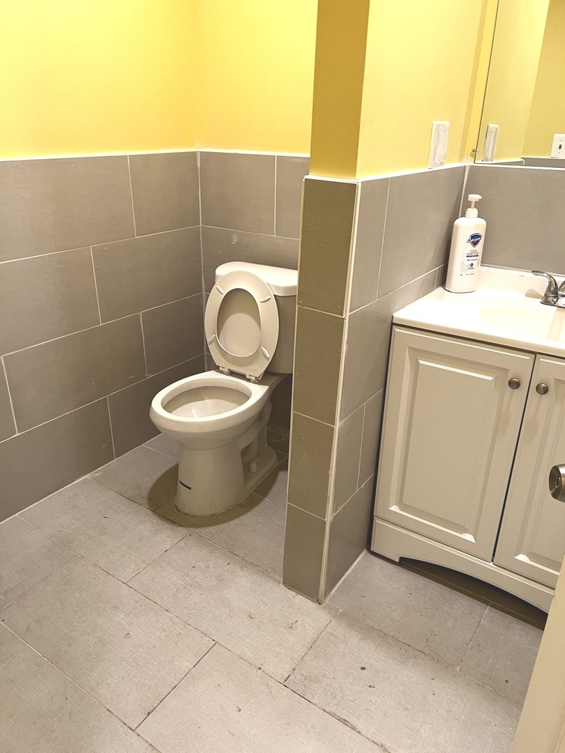2825 West Cermak Road Chicago, IL 60623 - Photo 13 of 21 a bathroom with a toilet and a sink