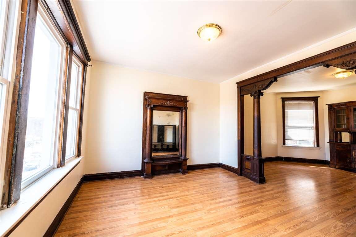 2825 West Cermak Road Chicago, IL 60623 - Photo 14 of 21 a view of an empty room with window and wooden floor
