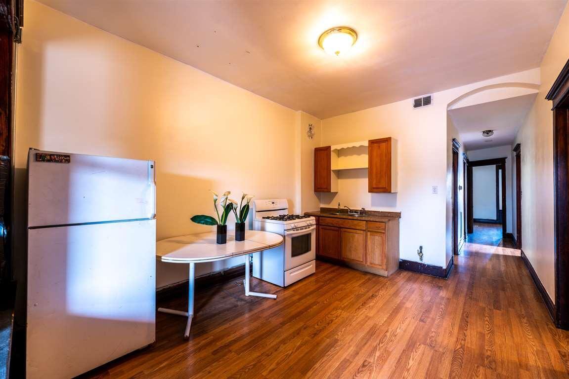 2825 West Cermak Road Chicago, IL 60623 - Photo 15 of 21 a kitchen with a refrigerator and a stove top oven