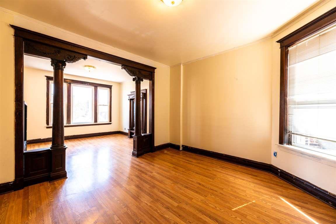 2825 West Cermak Road Chicago, IL 60623 - Photo 16 of 21 a view of an empty room with wooden floor and a window