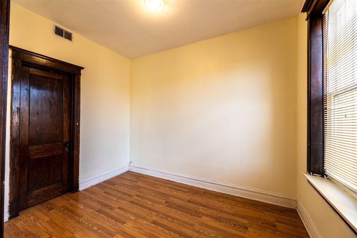 2825 West Cermak Road Chicago, IL 60623 - Photo 17 of 21 a view of empty room with wooden floor and fan