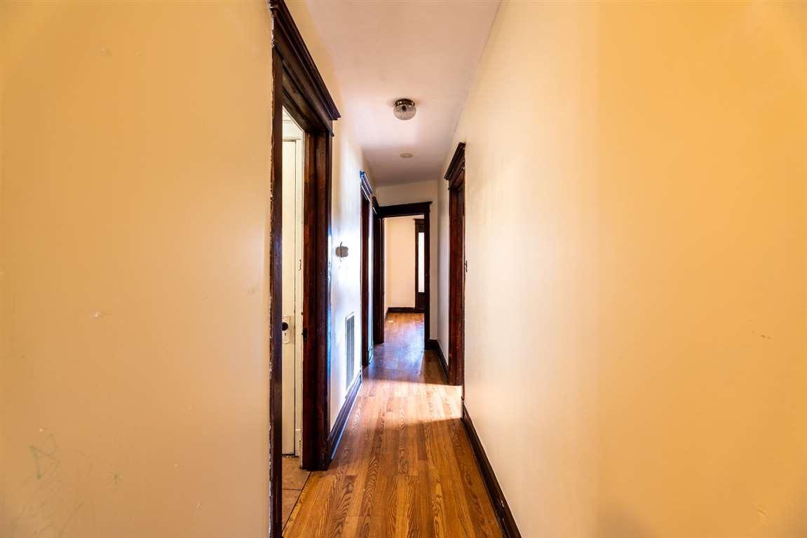 2825 West Cermak Road Chicago, IL 60623 - Photo 18 of 21 a view of a hallway with wooden floor and a bathroom