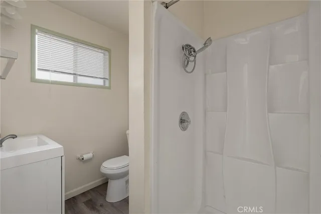 a bathroom with a toilet a sink and shower