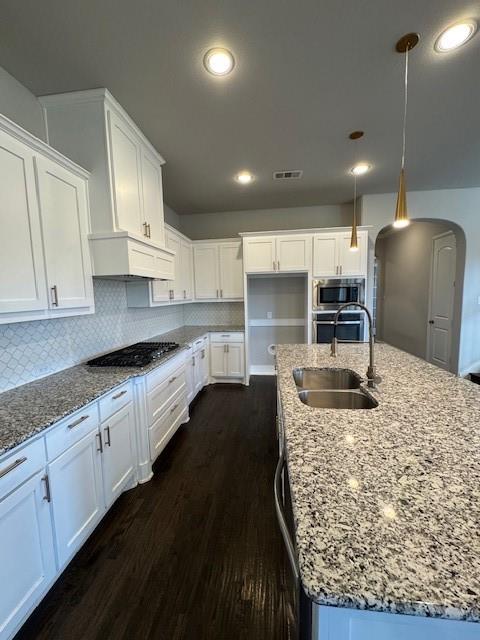 796 Huntingdon Street Coppell, TX 75019 - Photo 14 of 32 a large kitchen with kitchen island a sink stainless steel appliances and cabinets