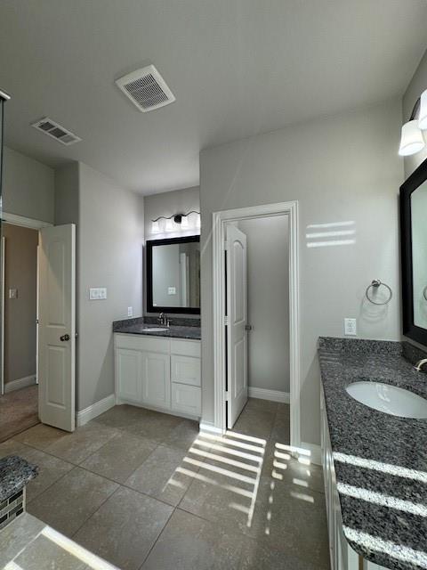 796 Huntingdon Street Coppell, TX 75019 - Photo 25 of 32 a bathroom with a granite countertop sink a mirror and a shower