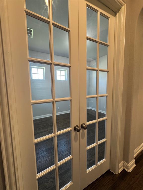 796 Huntingdon Street Coppell, TX 75019 - Photo 4 of 32 a view of an empty room with wooden floor and a window