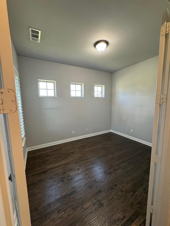 796 Huntingdon Street Coppell, TX 75019 - Photo 5 of 32 an empty room with wooden floor and windows