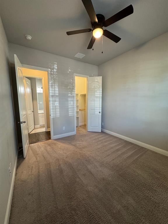 796 Huntingdon Street Coppell, TX 75019 - Photo 7 of 32 en empty room with windows and a ceiling fan