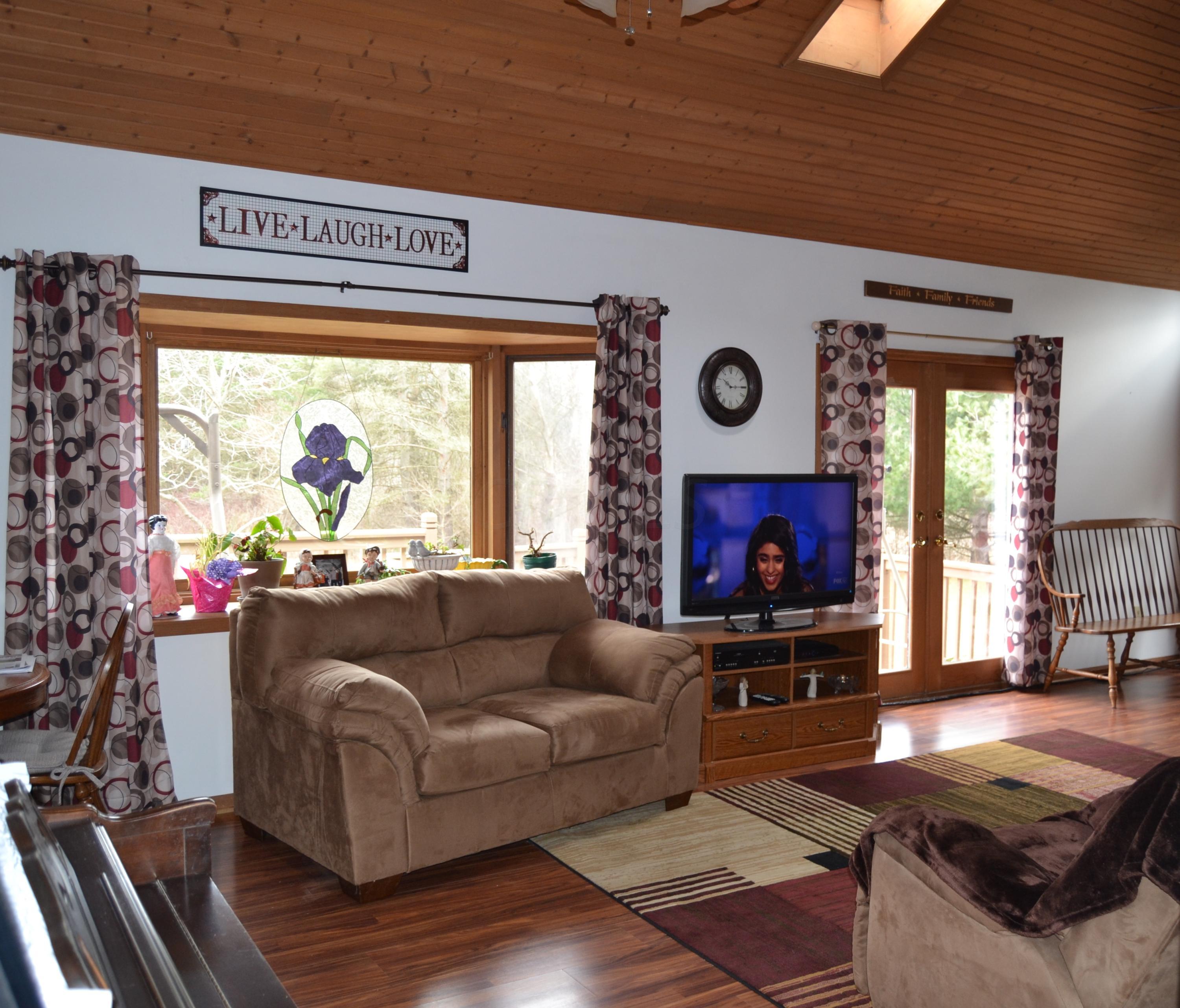 9000 Welsh Road Radnor, OH 43066 - Photo 2 of 28 26'8 x 14'0 SPACIOUS great room offering a vaulted wood ceiling with 2 skylights, lighted ceiling fan and a 2 sided fireplace. NEW laminate flooring and fresh paint Feb. 2016!