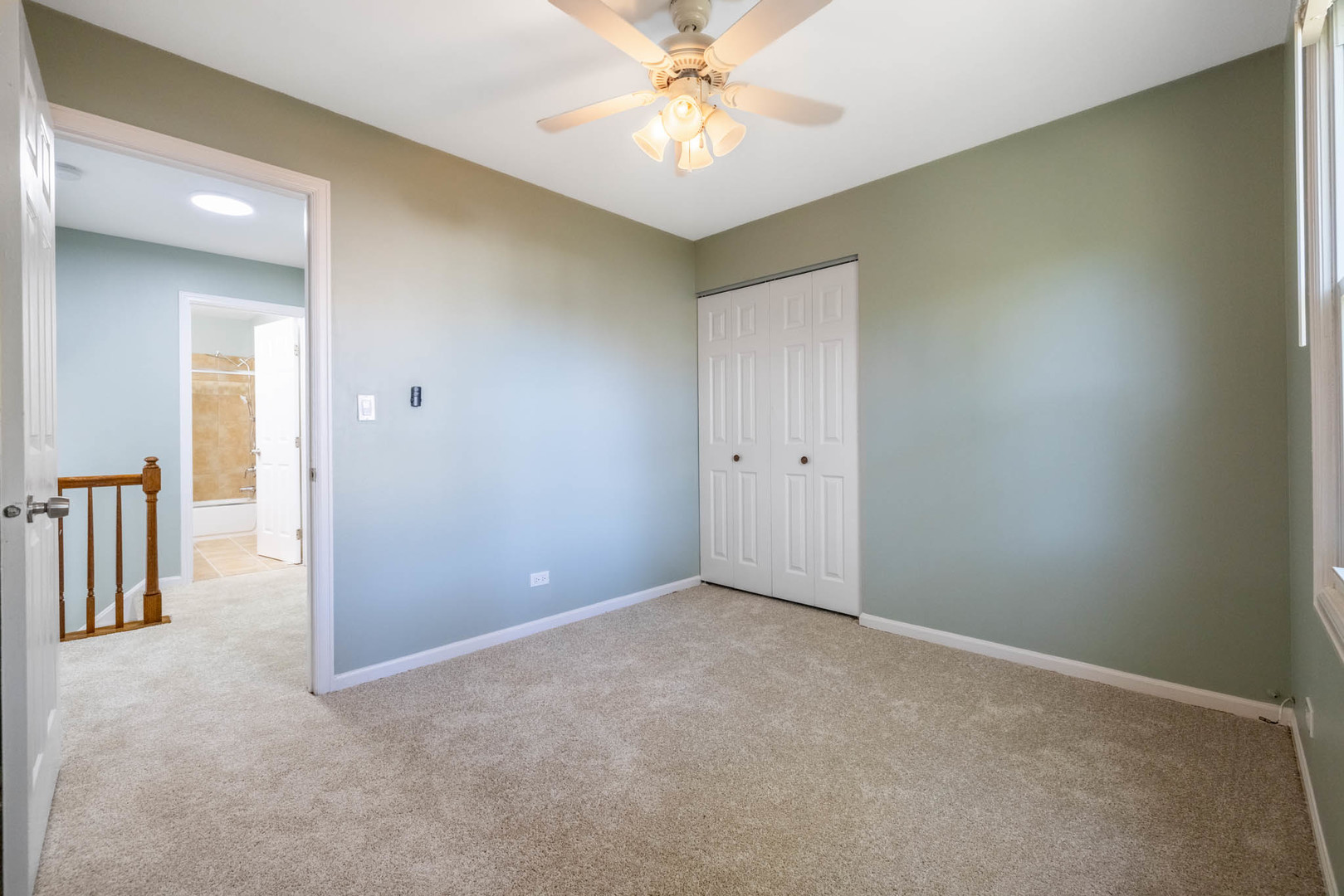 983 Stuart Drive Bartlett, IL 60103 - Photo 14 of 25 an empty room with closet and a chandelier fan