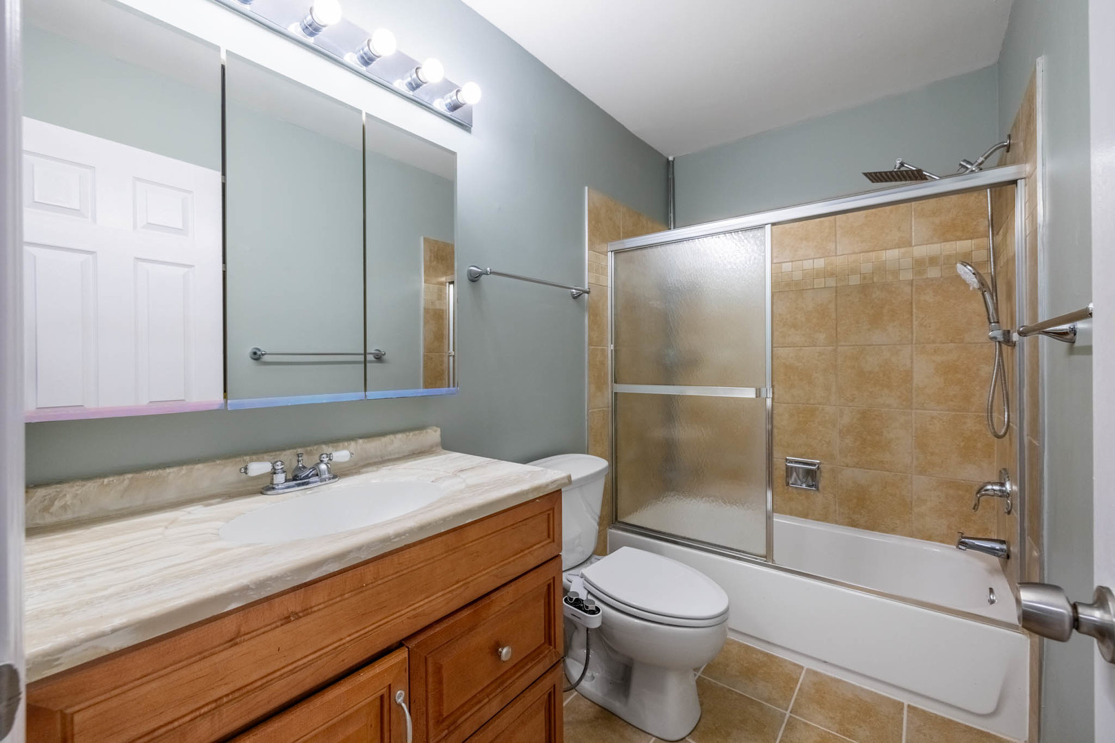 983 Stuart Drive Bartlett, IL 60103 - Photo 20 of 25 a bathroom with a sink a toilet and shower