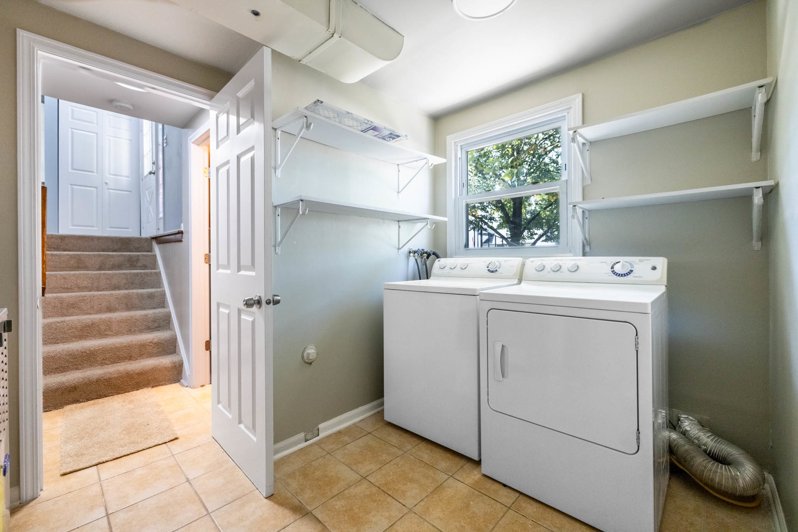 983 Stuart Drive Bartlett, IL 60103 - Photo 21 of 25 a utility room with cabinets washer and dryer