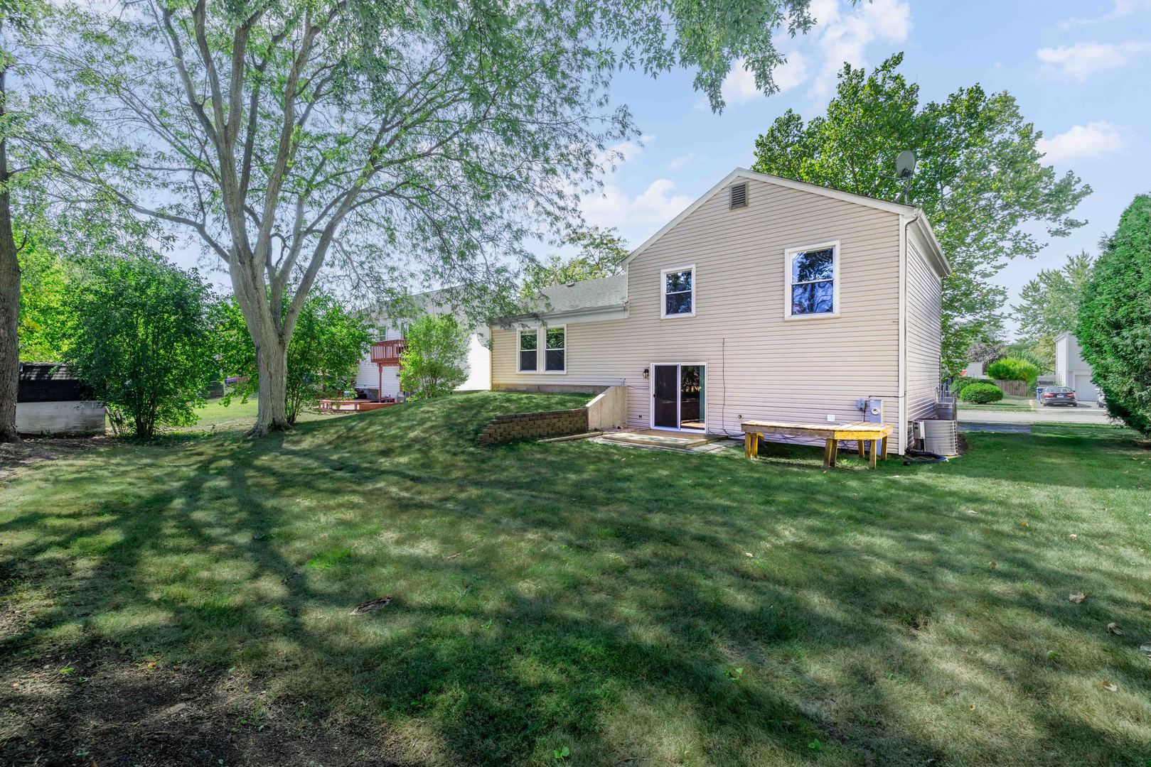 983 Stuart Drive Bartlett, IL 60103 - Photo 23 of 25 a view of a backyard with a white house