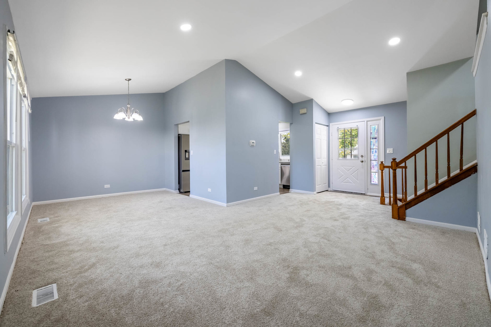 983 Stuart Drive Bartlett, IL 60103 - Photo 4 of 25 a view of an empty room with wooden floor and windows